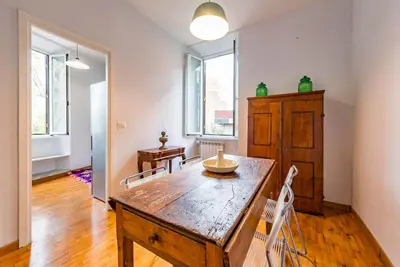 a dining room with a wooden table and chairs at La Casa dello Scrittore - Writer's Home in Rome
