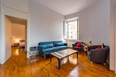 a living room with a blue couch and a table at La Casa dello Scrittore - Writer's Home in Rome