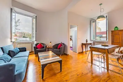 a living room with a blue couch and a table at La Casa dello Scrittore - Writer's Home in Rome