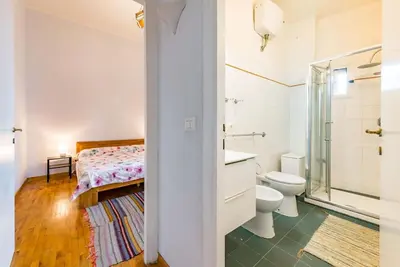a bathroom with a toilet and a sink and a shower at La Casa dello Scrittore - Writer's Home in Rome