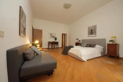 a living room with a bed and a couch at Giant Borghese Apartment in Rome
