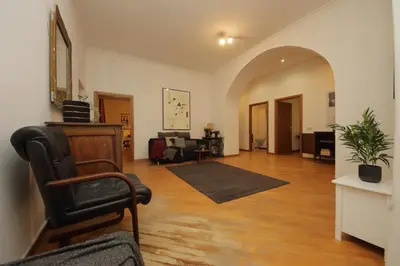 a living room with a chair and a couch at Giant Borghese Apartment in Rome