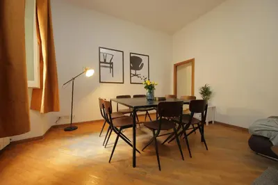 a dining room with a table and chairs at Giant Borghese Apartment in Rome