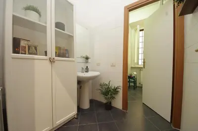 a bathroom with a sink and a toilet at Giant Borghese Apartment in Rome