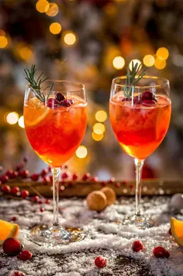 two wine glasses sitting on a table with a christmas tree at A casa di zia Anna in Rome
