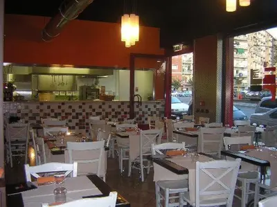 a restaurant with white tables and white chairs at A casa di zia Anna in Rome