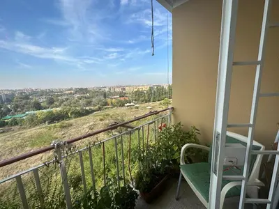a balcony with a chair and a view of a city at A casa di zia Anna in Rome
