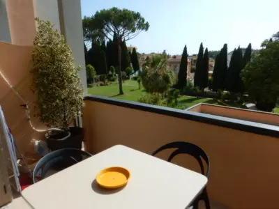a white table and chairs and a window with trees at Domus Aurelia Studio Apartments in Rome