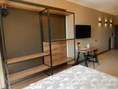 a room with a bed and a desk and a television at Domus Aurelia Studio Apartments in Rome