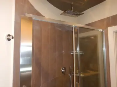 a shower with a glass door in a bathroom at Domus Aurelia Studio Apartments in Rome