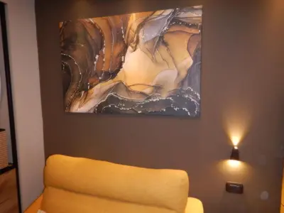a painting hanging on a wall next to a couch at Domus Aurelia Studio Apartments in Rome