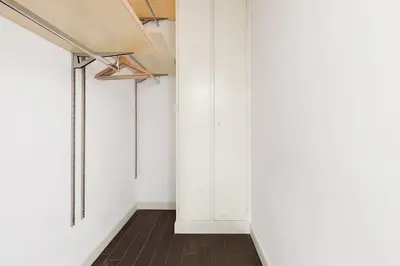 a hallway with white walls and a wood floor at Re-Imagined Apartment in Historical Building in Rome
