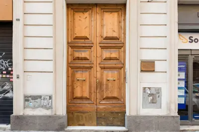 a wooden door on the side of a building at Re-Imagined Apartment in Historical Building in Rome