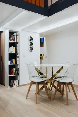 a dining room with a glass table and two chairs at Modern loft in central Rome in Rome