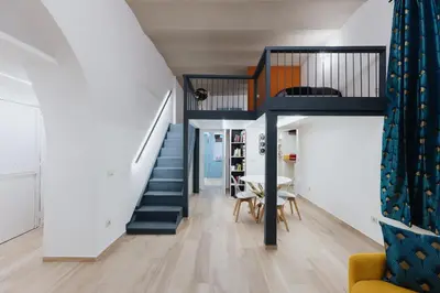 a staircase in a house with a table and a dining room at Modern loft in central Rome in Rome