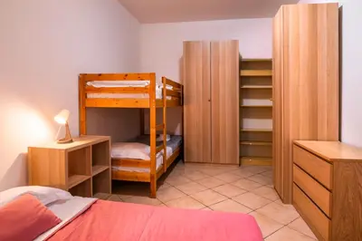 a bedroom with a bunk bed and a closet at Spacious Apartment near St Peter's Church in Rome