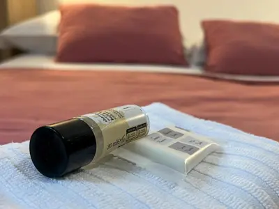 a bottle of thermometer sitting on top of a bed at Spacious Apartment near St Peter's Church in Rome