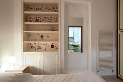 a bedroom with a bed and a desk and a mirror at Spacious Apartment near St Peter's Church in Rome