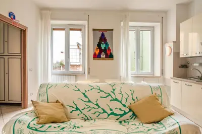 a living room with a couch and two windows at Spacious Apartment near St Peter's Church in Rome