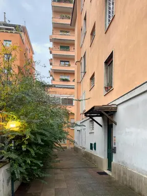 an empty alley in front of a tall building at Spacious Apartment near St Peter's Church in Rome