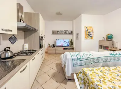 a kitchen and living room with a stove at Spacious Apartment near St Peter's Church in Rome