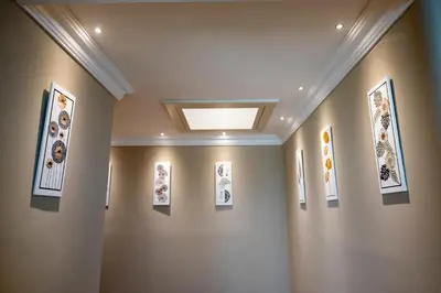 a hallway with framed pictures on a wall at Domus Aurelia Luxury in Rome