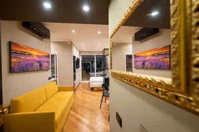 a living room with a couch and paintings on the wall at Domus Aurelia Luxury in Rome