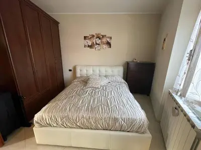 a small bedroom with a bed in the corner at Roma Battistini 66 Apartment, near Vatican City in Rome