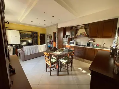 a kitchen with a table and chairs and a couch at Roma Battistini 66 Apartment, near Vatican City in Rome