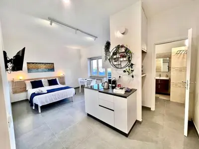a bedroom with a bed and a desk in a room at White Mary House for two people in Rome