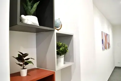 a room with a shelf with potted plants on it at White Mary House for two people in Rome