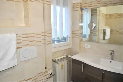 a bathroom with a sink and a mirror at White Mary House for two people in Rome