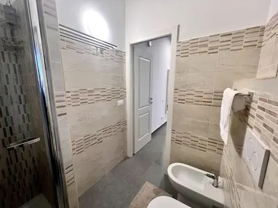 a bathroom with a toilet and a sink at White Mary House for two people in Rome