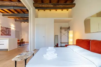 a bedroom with a white bed and a red couch at Titta's Dream by BuddyRent in Rome