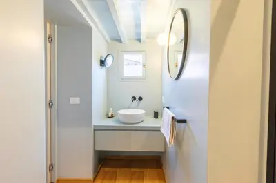 a bathroom with a sink and a mirror at Titta's Dream by BuddyRent in Rome
