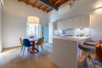 a kitchen and dining room with a table and chairs at Titta's Dream by BuddyRent in Rome