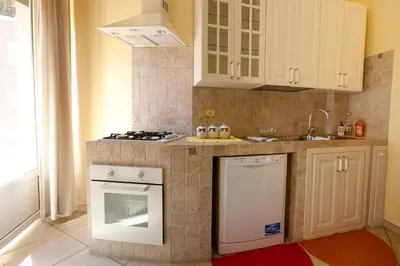 a kitchen with a stove top oven next to a sink at Sophie's Choice 2 in Rome