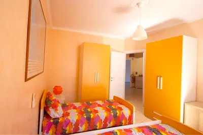 a bedroom with a bed and yellow cabinets at Sophie's Choice 2 in Rome