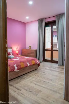 a bedroom with a bed and a purple wall at Sophie's Choice 2 in Rome