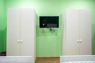 a room with white cabinets with a tv on the wall at Sophie's Choice 2 in Rome