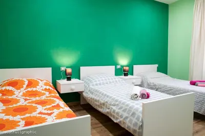 two beds in a room with green walls at Sophie's Choice 2 in Rome