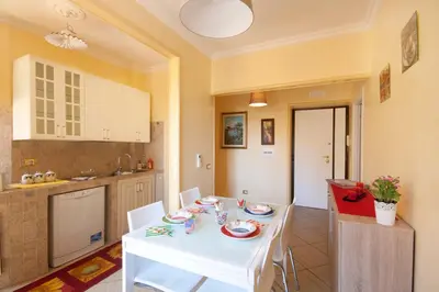 a kitchen and dining room with a white table and chairs at Sophie's Choice 2 in Rome
