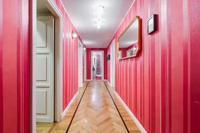 a hallway with red walls and a mirror at Salotto Trastevere in Rome