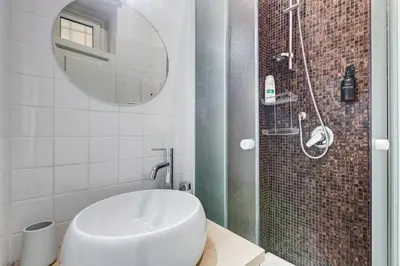 a bathroom with a sink and a shower at Salotto Trastevere in Rome