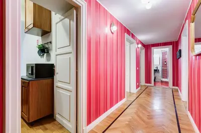 a hallway with red walls and wooden floors at Salotto Trastevere in Rome