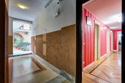 a hallway with red doors and a tile floor at Salotto Trastevere in Rome