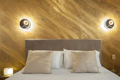 a bedroom with a bed with two lights on the wall at Campo de Fiori Charming Accommodation in Rome