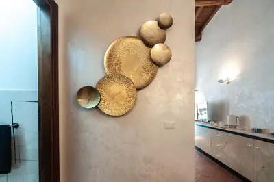 a group of plates on the wall of a kitchen at Campo de Fiori Charming Accommodation in Rome