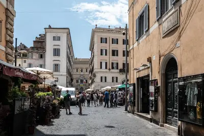 a group of people walking down a street with buildings at Campo de Fiori Charming Accommodation in Rome