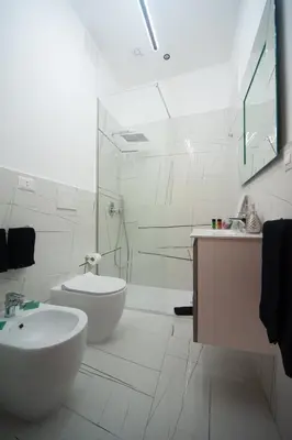 a white bathroom with a sink and a shower at Campo de Fiori Charming Accommodation in Rome